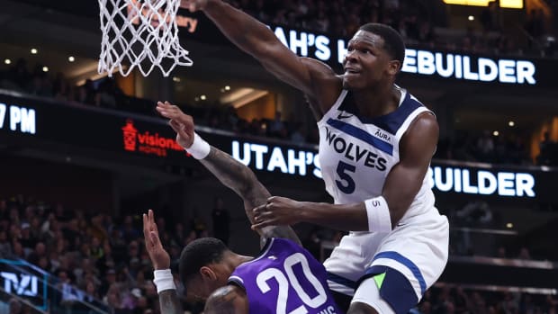 Mar 18, 2024; Salt Lake City, Utah, USA; Minnesota Timberwolves guard Anthony Edwards (5) dunks the ball against Utah Jazz forward John Collins (20) during the third quarter at Delta Center. 